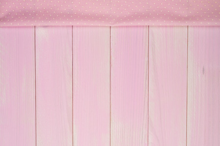 Pink towel over wooden kitchen table. View from above.の写真素材