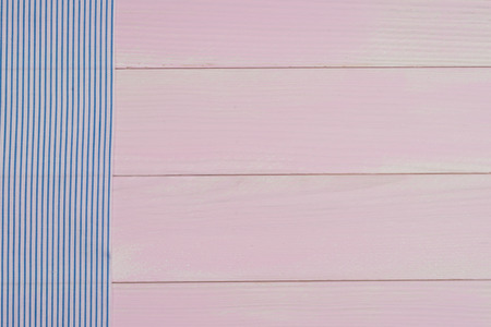 Blue striped towel over the surface of a wooden table.の写真素材