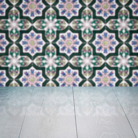 Empty wood table top and blur vintage ceramic tile pattern wall in background, Mock up template for display of your product.の写真素材