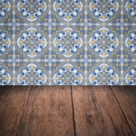 Empty wood table top and blur vintage ceramic tile pattern wall in background, Mock up template for display of your product.の写真素材