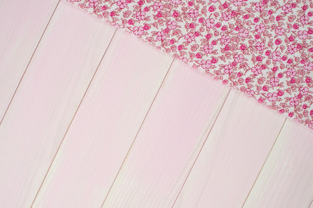 Pink towel over wooden kitchen table. View from above.の写真素材