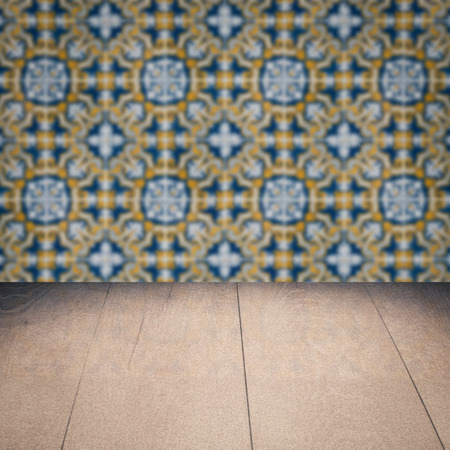 Empty wood table top and blur vintage ceramic tile pattern wall in backgroundの写真素材