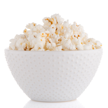 Popcorn in a white bowl on a white backgroundの写真素材
