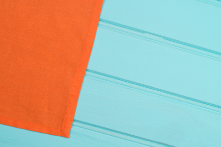 Orange towel over wooden kitchen table. View from above.の写真素材