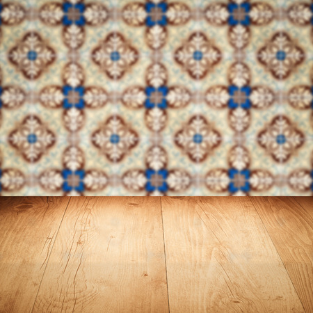 Empty wood table top and blur vintage ceramic tile pattern wall in background, Mock up template for display of your product.の写真素材