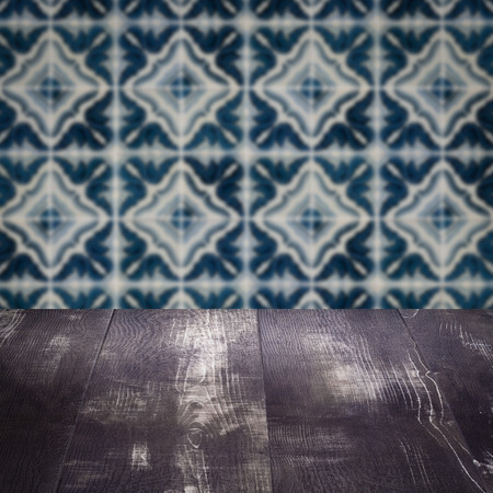 Empty wood table top and blur vintage ceramic tile pattern wall in background, Mock up template for display of your product.の写真素材