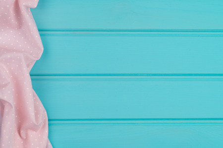 Pink towel over wooden kitchen table. View from above.の写真素材