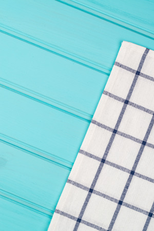Blue and white towel over the surface of a wooden table.の写真素材