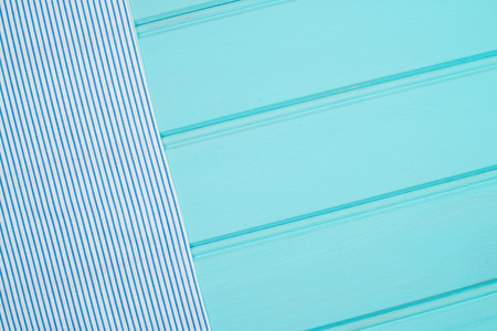 Blue and white towel over the surface of a wooden table.の写真素材