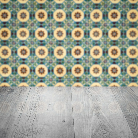 Empty wood table top and blur vintage ceramic tile pattern wall in background, Mock up template for display of your product.の写真素材