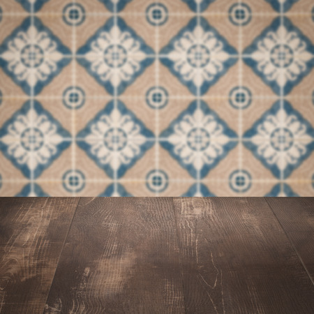 Empty wood table top and blur vintage ceramic tile pattern wall in background, Mock up template for display of your product.の写真素材