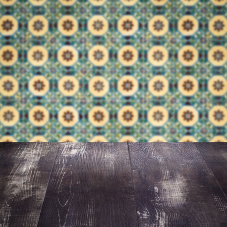 Empty wood table top and blur vintage ceramic tile pattern wall in background, Mock up template for display of your product.の写真素材