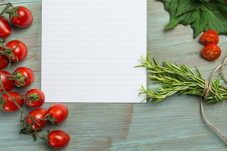 Blank white paper and fresh colorful vegetables on kitchen tableの写真素材