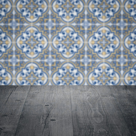 Empty wood table top and blur vintage ceramic tile pattern wall in background, Mock up template for display of your product.の写真素材