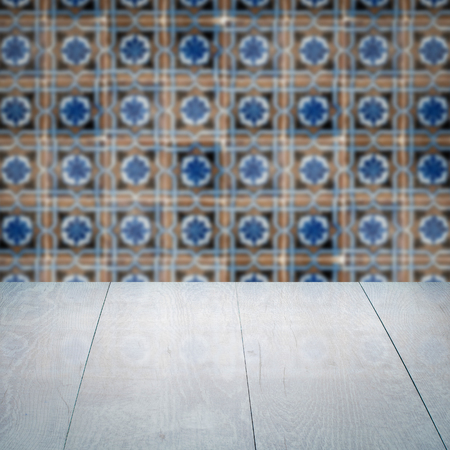Empty wood table top and blur vintage ceramic tile pattern wall in background, Mock up template for display of your product.の写真素材