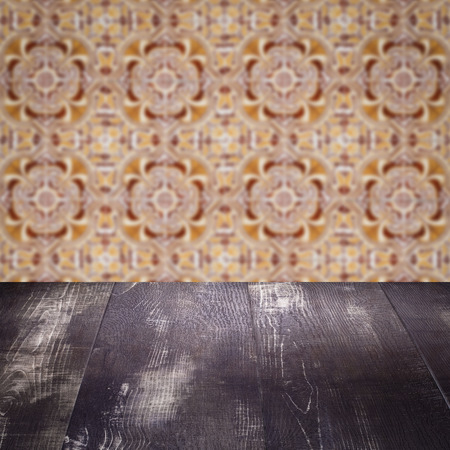 Empty wood table top and blur vintage ceramic tile pattern wall in backgroundの写真素材