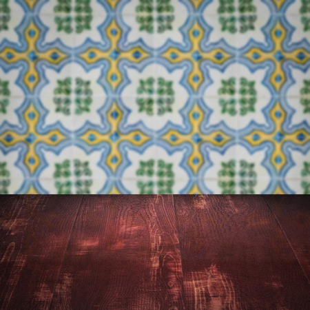 Empty wood table top and blur vintage ceramic tile pattern wall in background