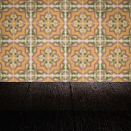 Empty wood table top and blur vintage ceramic tile pattern wall in background