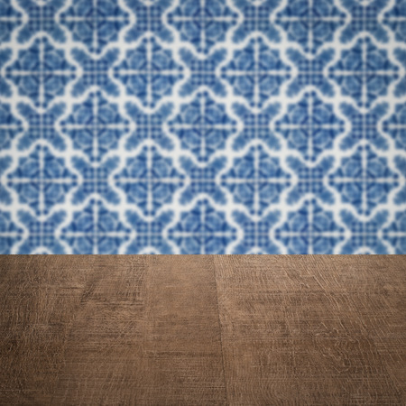 Empty wood table top and blur vintage ceramic tile pattern wall in backgroundの写真素材