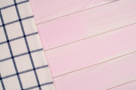 Blue striped towel over the surface of a wooden table.の写真素材