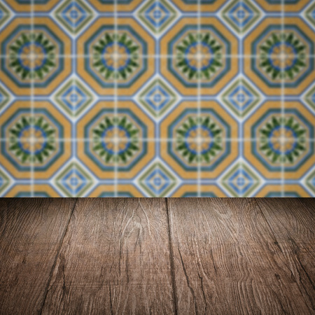 Empty wood table top and blur vintage ceramic tile pattern wall in backgroundの写真素材