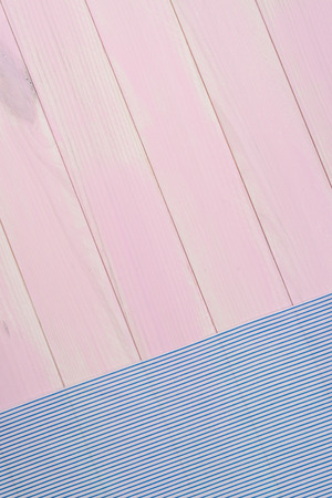 Blue striped towel over the surface of a wooden table.の写真素材