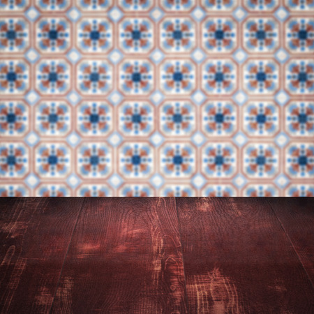 Empty wood table top and blur vintage ceramic tile pattern wall in background, Mock up template for display of your product.の写真素材