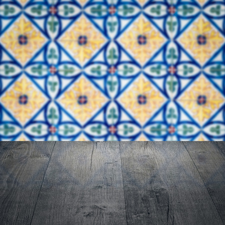 Empty wood table top and blur vintage ceramic tile pattern wall in background, Mock up template for display of your product.の写真素材