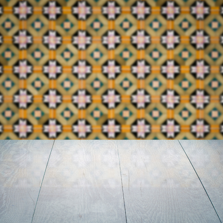 Empty wood table top and blur vintage ceramic tile pattern wall in backgroundの写真素材