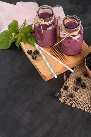 Fresh red fruits smoothie on vintage decorated  wooden table.の写真素材