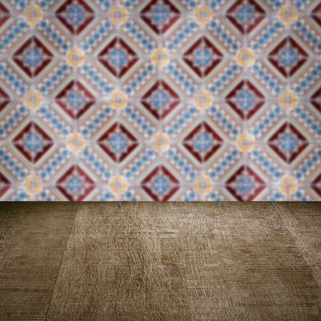 Empty wood table top and blur vintage ceramic tile pattern wall in background, Mock up template for display of your product.の写真素材