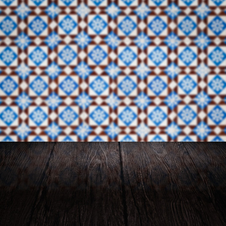Empty wood table top and blur vintage ceramic tile pattern wall in background, Mock up template for display of your product.の写真素材