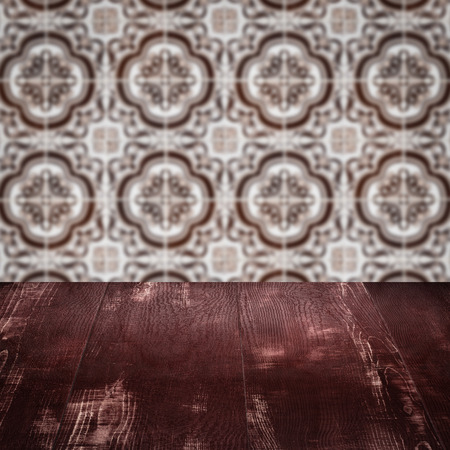 Empty wood table top and blur vintage ceramic tile pattern wall in background, Mock up template for display of your product.の写真素材