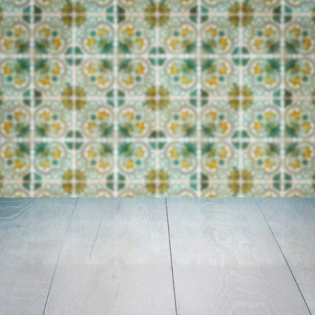 Empty wood table top and blur vintage ceramic tile pattern wall in background, Mock up template for display of your product.の写真素材