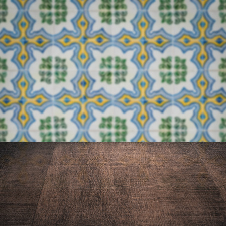 Empty wood table top and blur vintage ceramic tile pattern wall in backgroundの写真素材