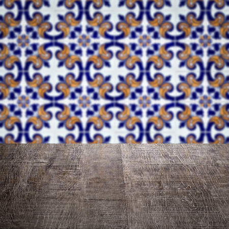 Empty wood table top and blur vintage ceramic tile pattern wall in background, Mock up template for display of your product.の写真素材