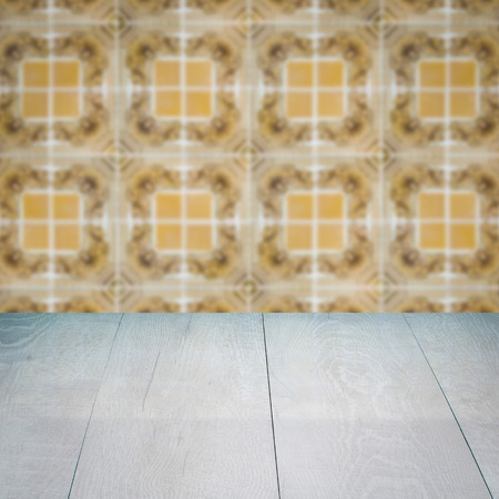 Empty wood table top and blur vintage ceramic tile pattern wall in background, Mock up template for display of your product.の写真素材