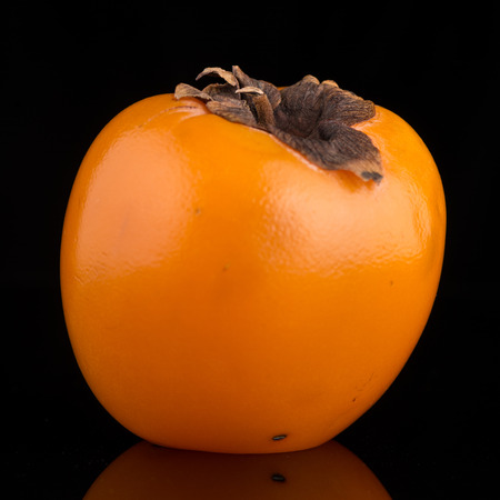 Persimmon fruit on black background.の写真素材