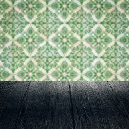 Empty wood table top and blur vintage ceramic tile pattern wall in backgroundの写真素材