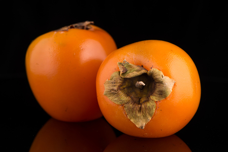 Persimmon fruits on black background.の写真素材