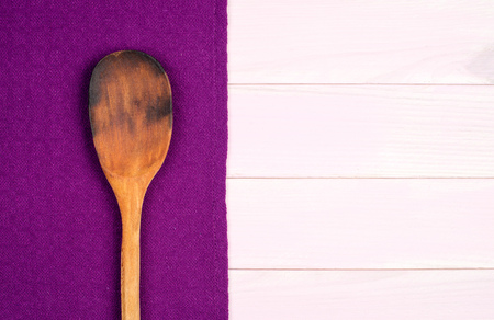 Kitchenware on purple towel over wooden kitchen table. View from above.の写真素材
