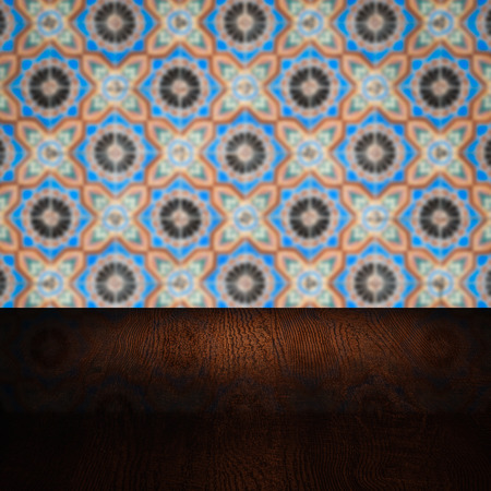 Empty wood table top and blur vintage ceramic tile pattern wall in background, Mock up template for display of your product.の写真素材