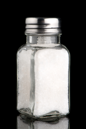 Salt shaker on black Background.の写真素材