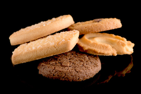 Butter cookies isolated on black background. Closeup.