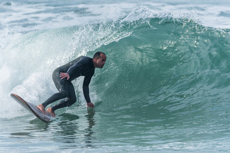 Surfer in action on the ocean waves on a sunny day.の写真素材