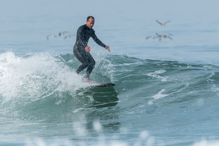 Surfer in action on the ocean waves on a sunny day.