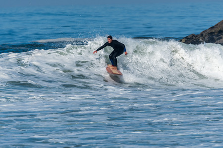 Surfer in action on the ocean waves on a sunny day.の写真素材