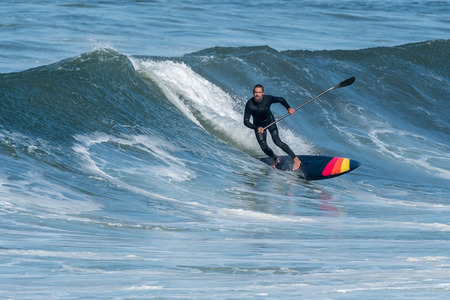 Stand up paddle surfer on the atlantic ocean.