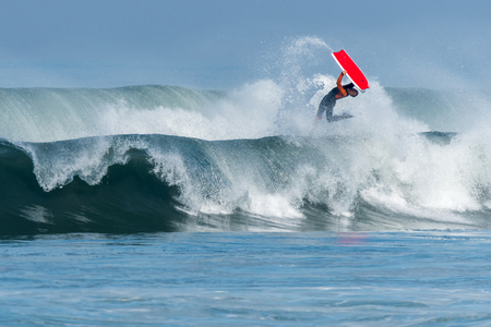 Bodyboarder in action on the ocean waves on a sunny day.の写真素材