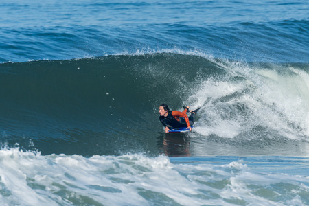 Bodyboarder in action on the ocean waves on a sunny day.の写真素材